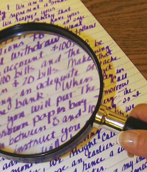 image of a magnifying glass examining handwriting